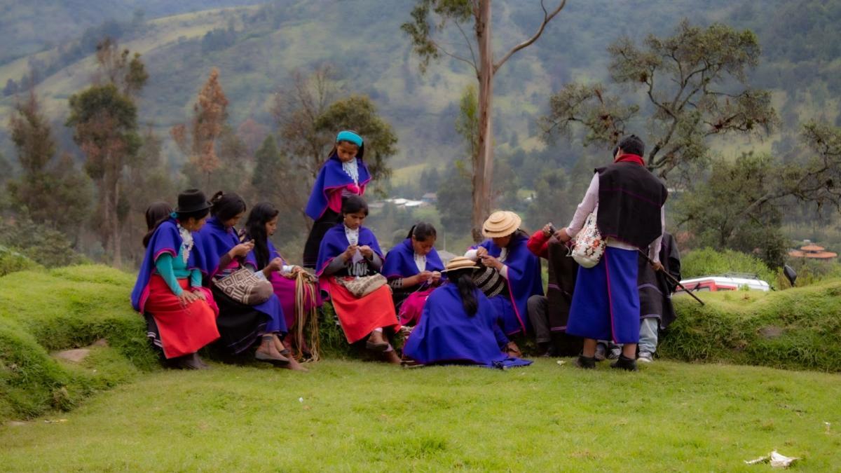 A group of women work on weaving baskets