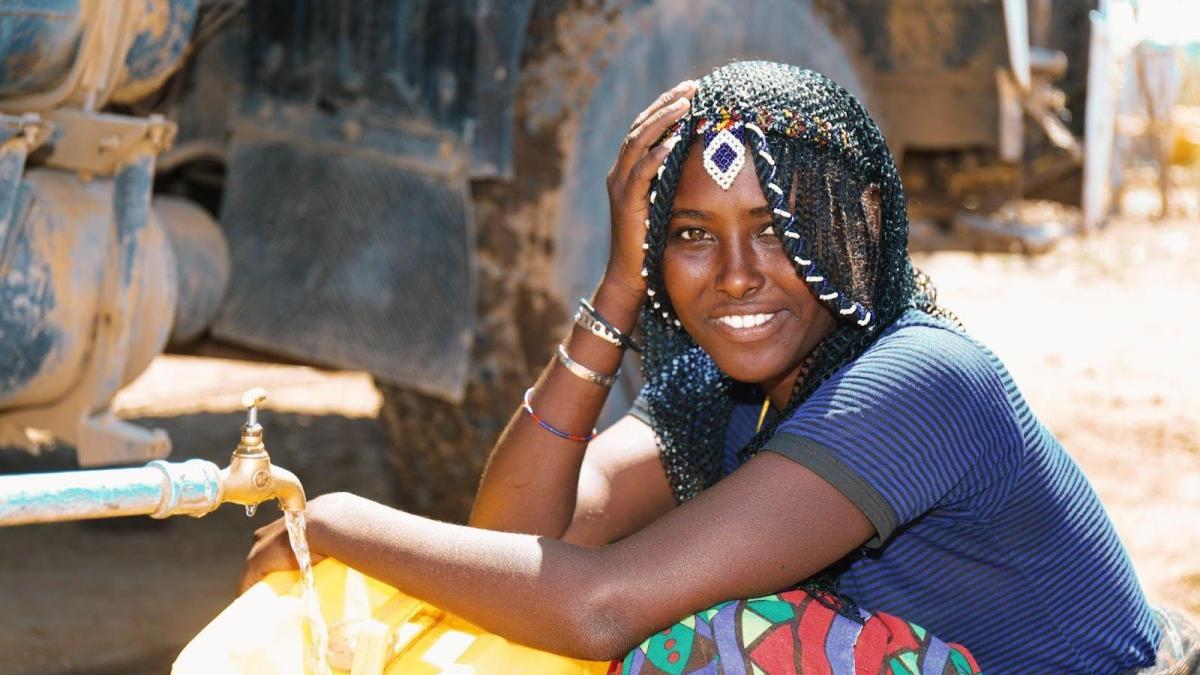 A woman smiles at the camera