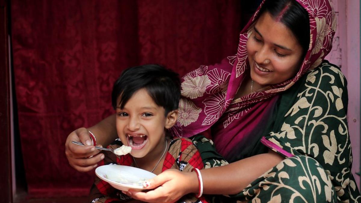 Mother feeding young child