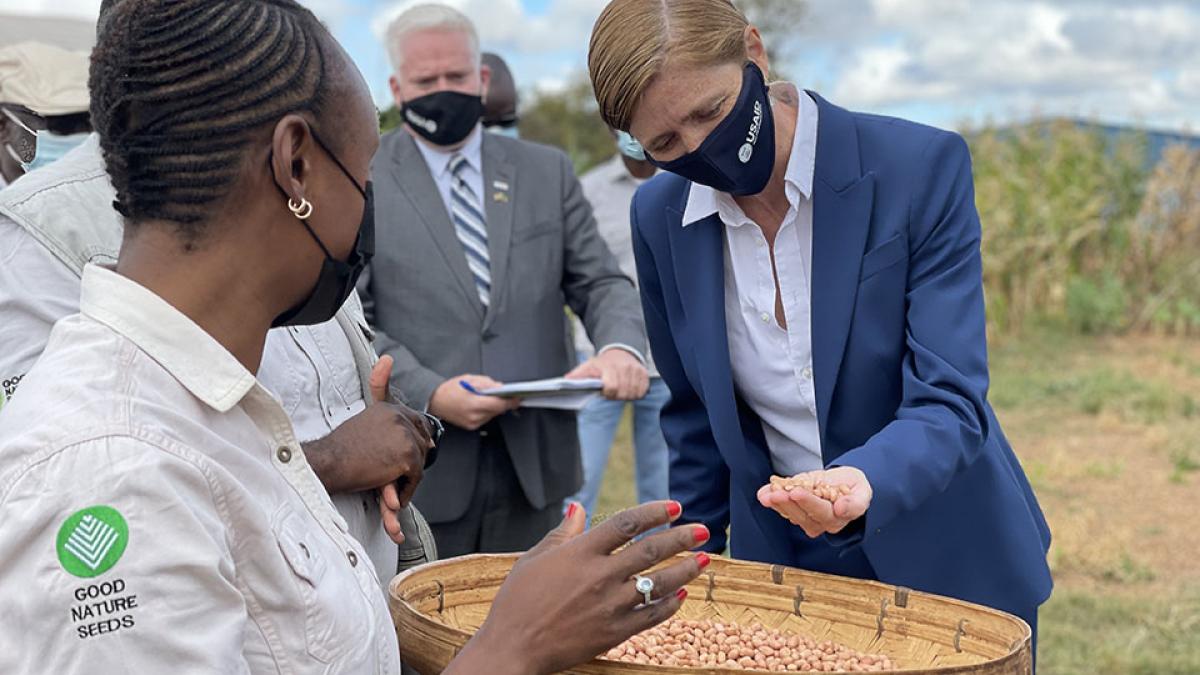 Administrator Power with some beans in her hand out in a field