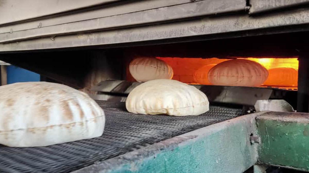 Baked bread exits the oven.