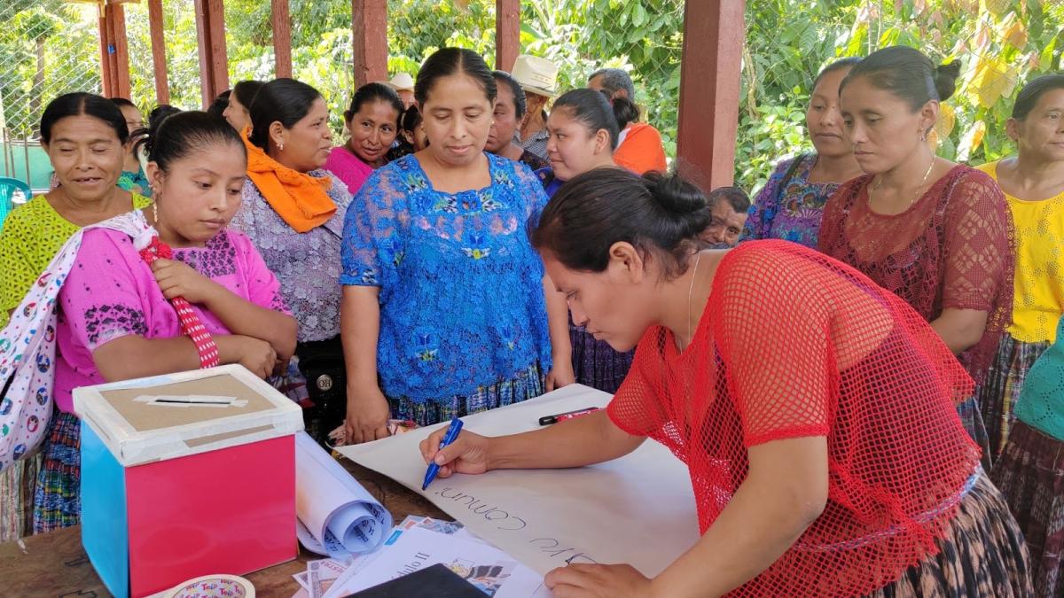 a group of women create hand-written posters