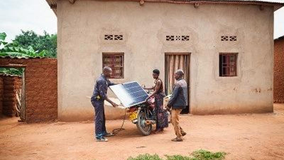 People with solar panels outside a house