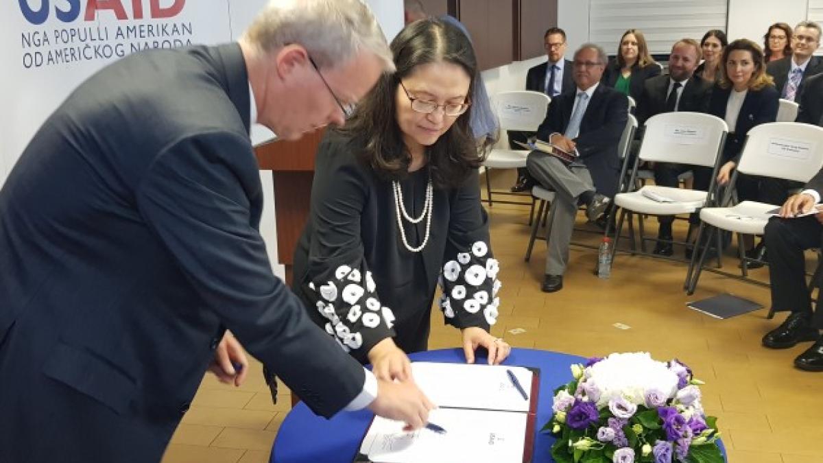 USAID Kosovo Swearing in Ceremony: Ambassador Delawie and Lisa Magno sign the Oath of Office