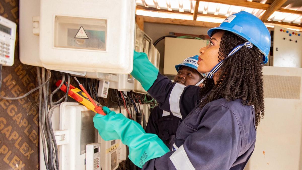 A woman installing an electricity meter.