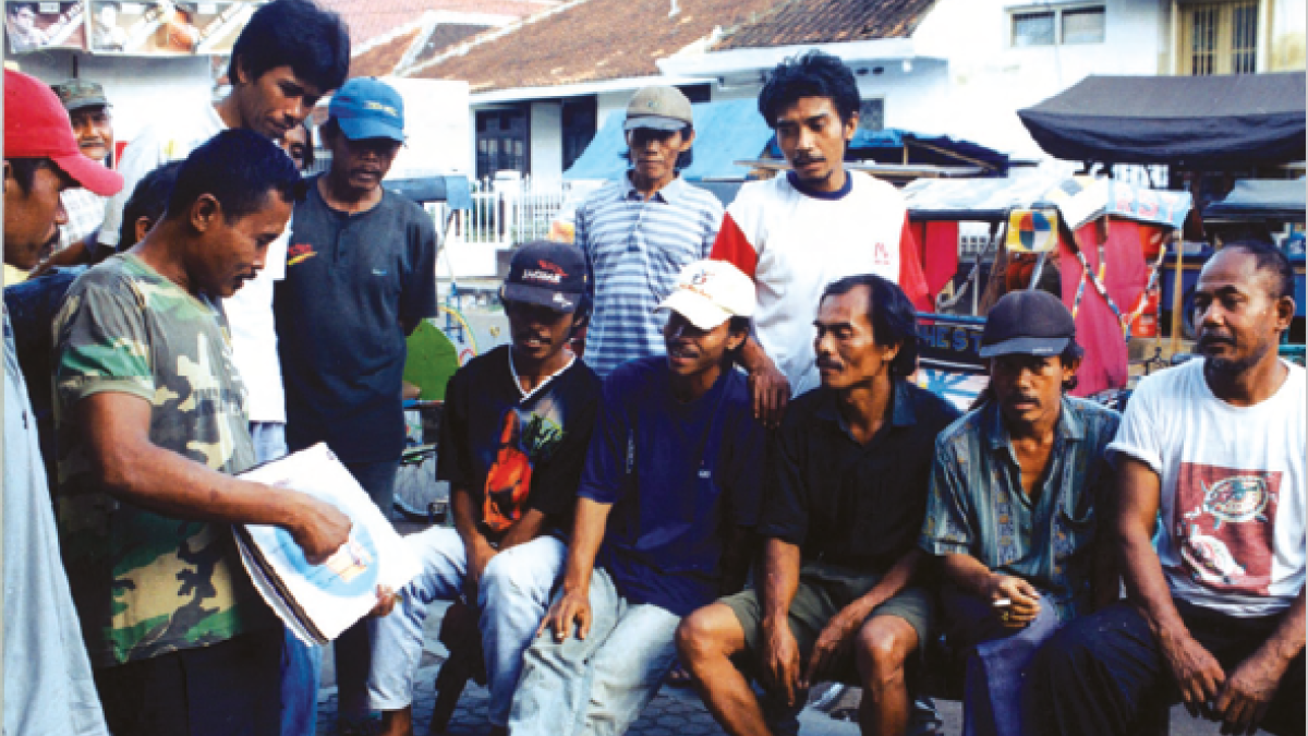 A group of men learn about family planning in a community education session