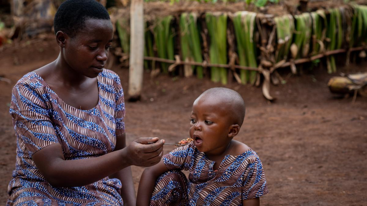 Mother feeding young child