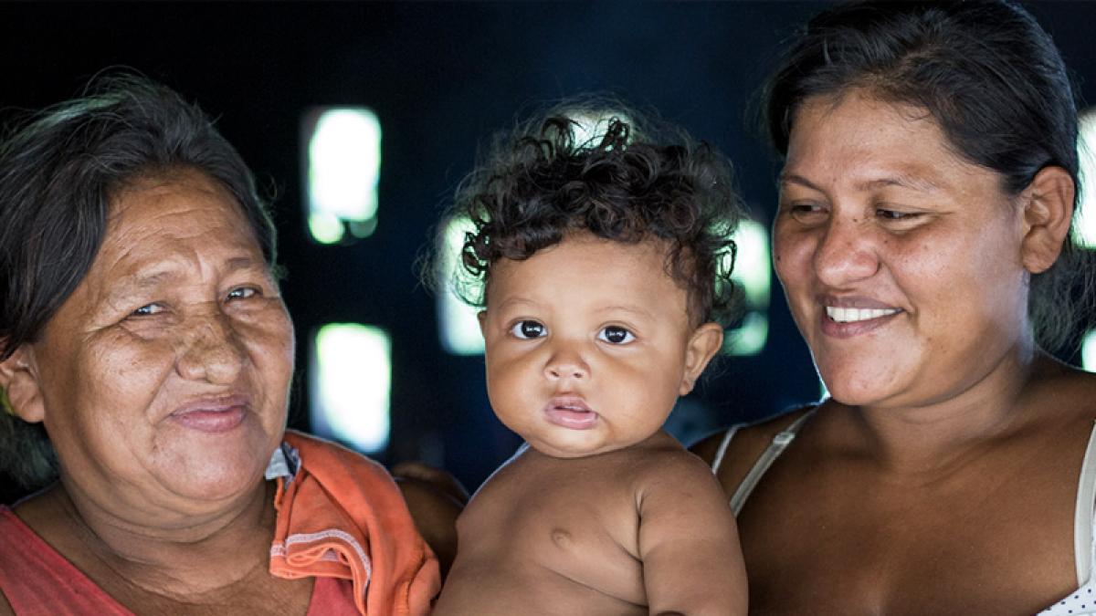 Close up photo of two women with a child