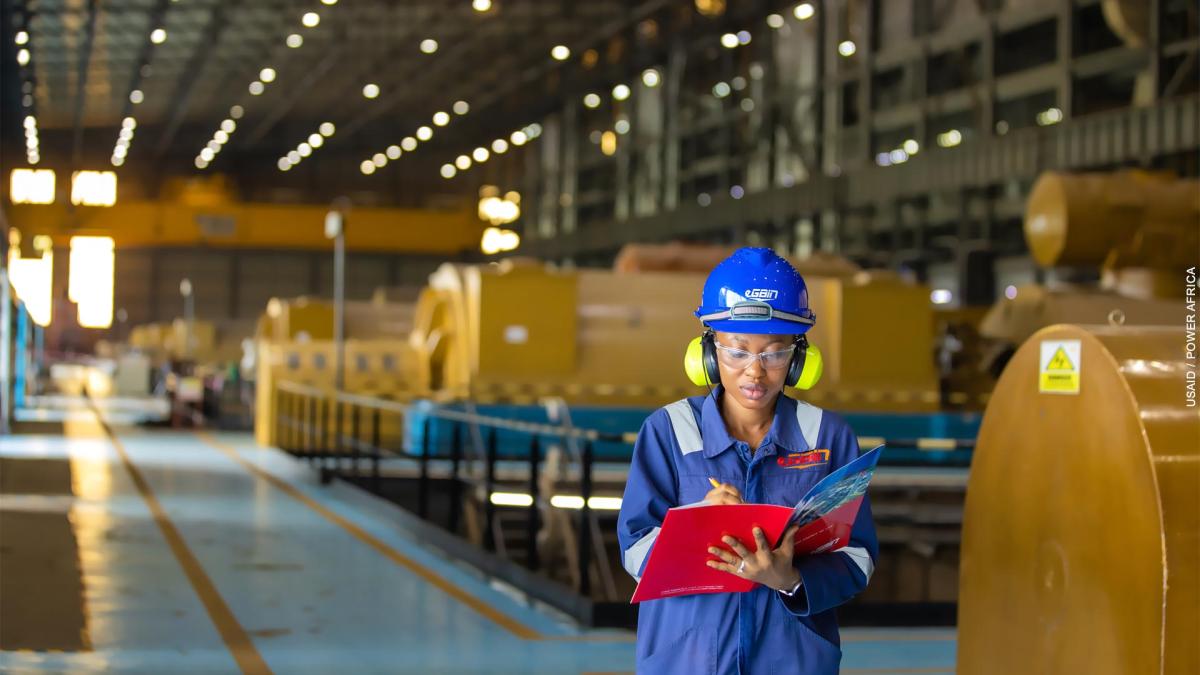 A female Egbin Power engineer performs an equipment check in the generation station