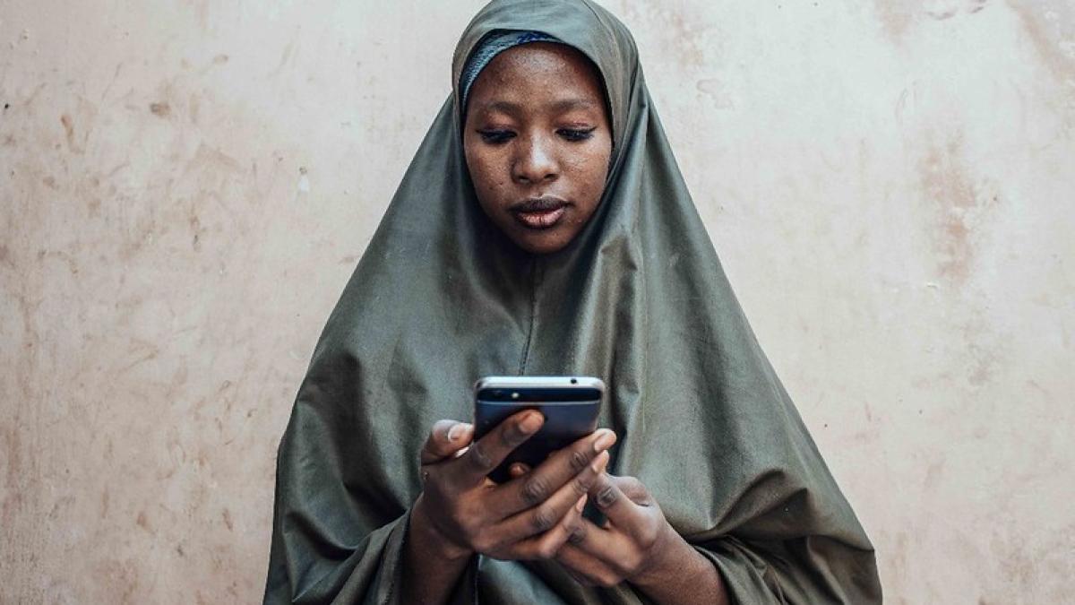 A woman uses a handheld device