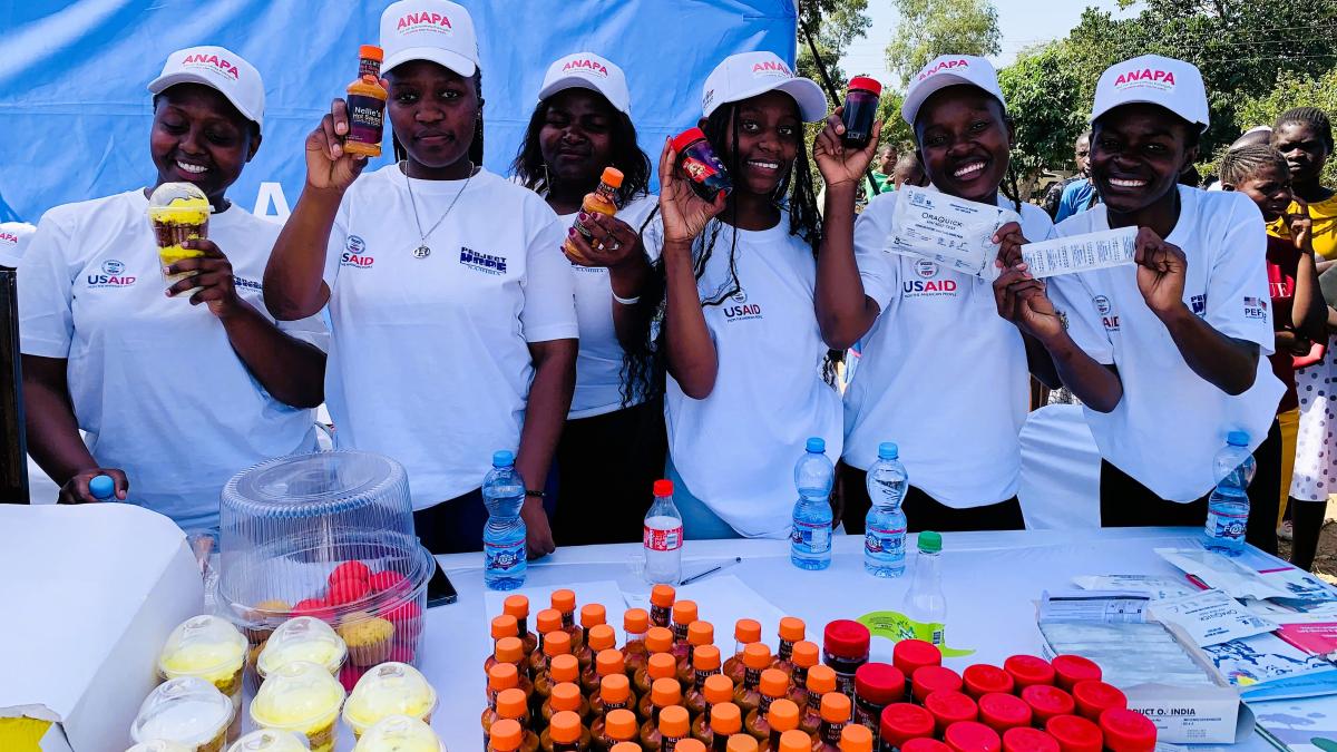 Youthful beneficiaries display their merchandise made using skills from the program, which also aims to empower the youth and adolescents to be economically independent as a way of deterring them from risky behaviour. Photo Credit: Oris Chimenya/USAID