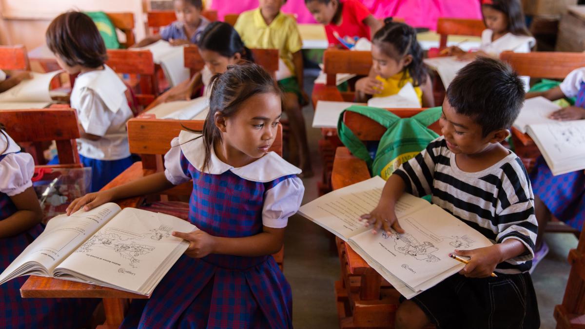 Children reading in a classroom in the Philippines.