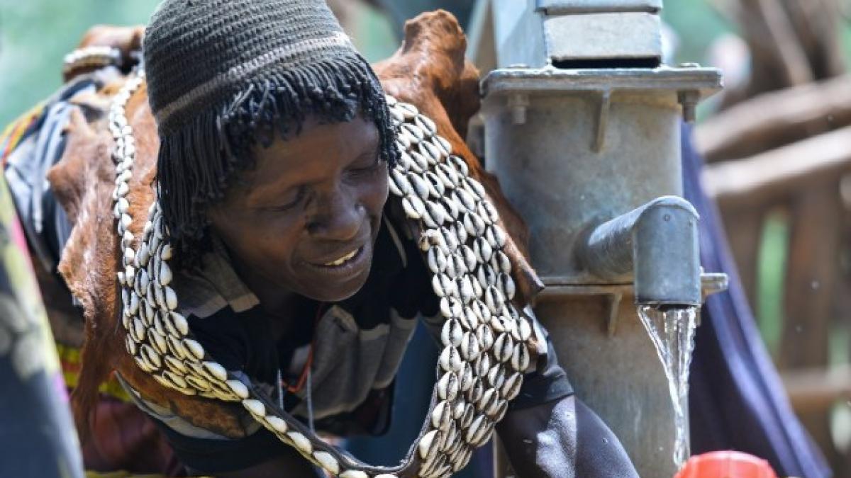 A woman fills her containers with water from a pump built by a USAID water and sanitation project in Era, Ethiopia. Photo credit: AECOM.