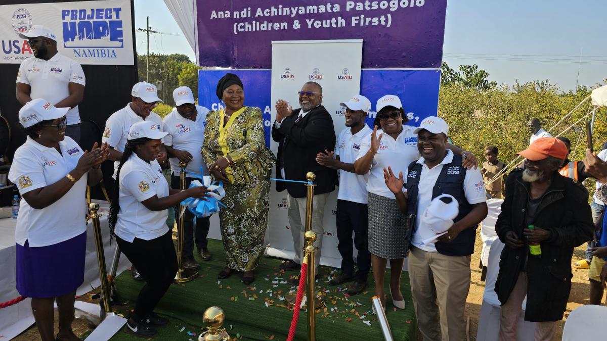 Minister of Gender, Community Development, and Social Welfare Jean Sendeza and USAID Deputy Health Office Director Dr. Haldon Njikho celebrate after cutting the ribbon to launch the new program. Photo Credit: Oris Chimenya/USAID