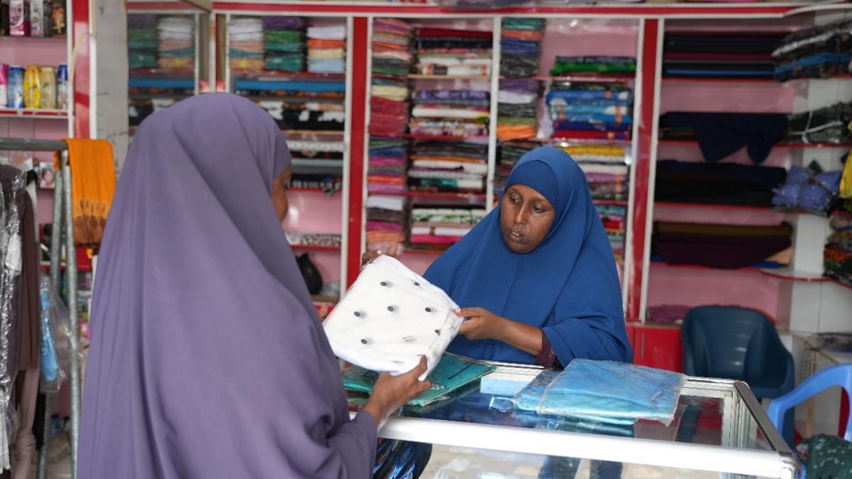 Ubah with a customer in her shop. USAID supported IBS Bank to develop micro-credit facilities and products for the marginalized groups in Somalia