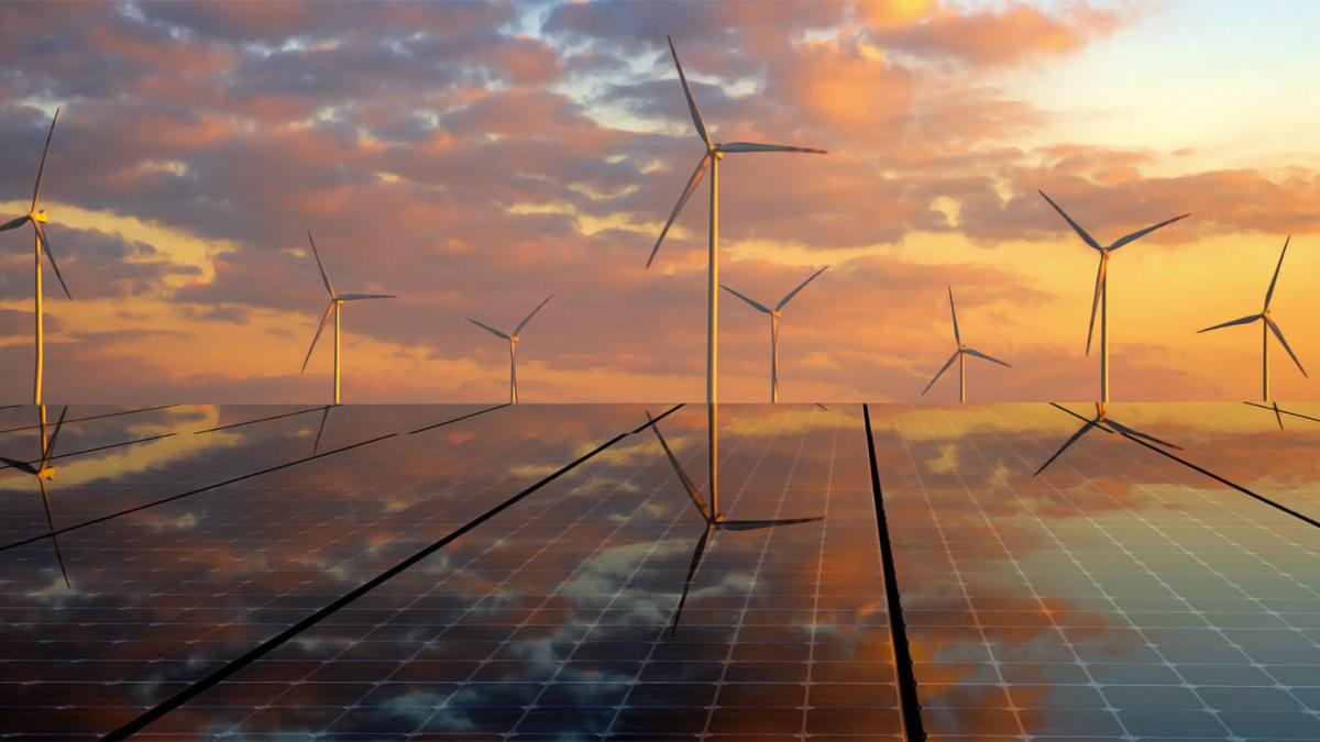 Solar panels and wind turbines at sunset