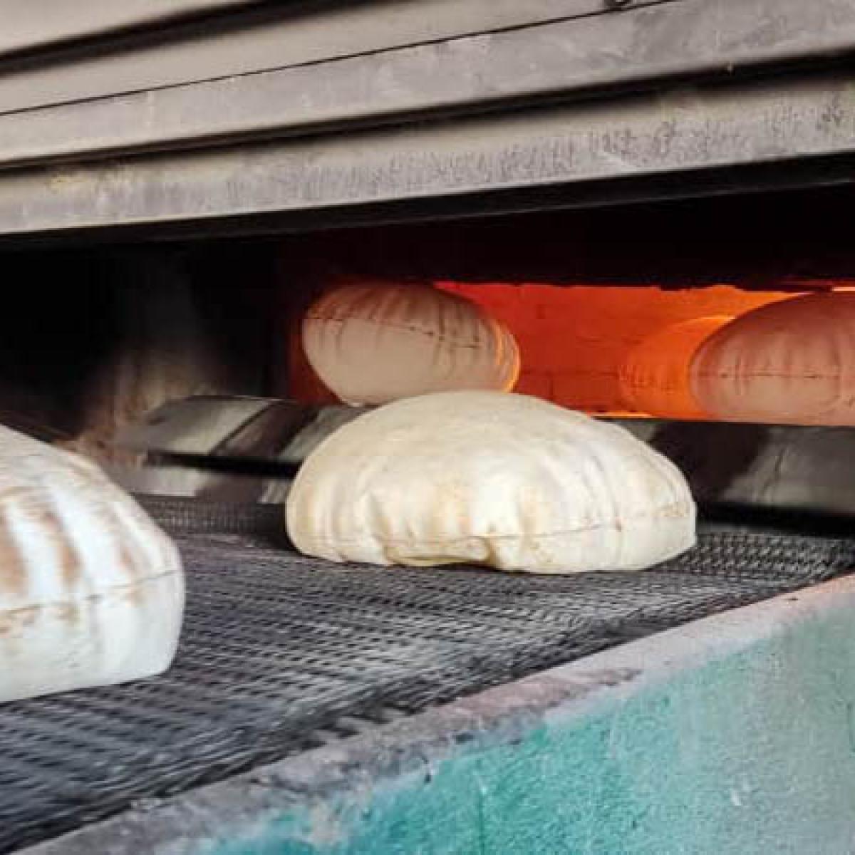 Baked bread exits the oven.