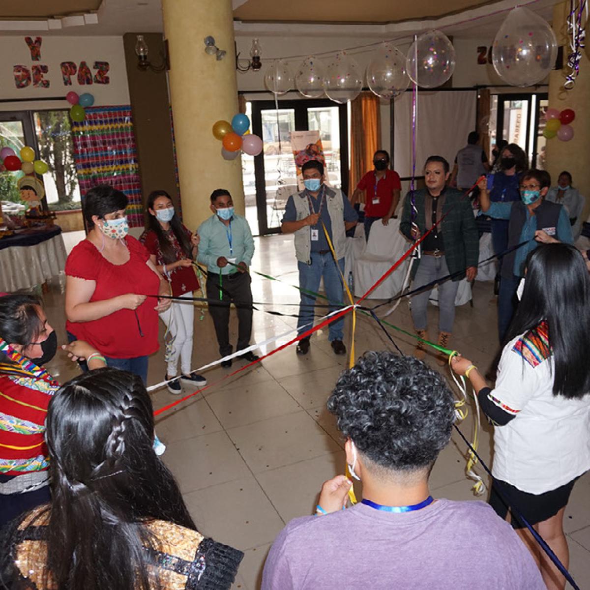 Group in a circle holding ribbons