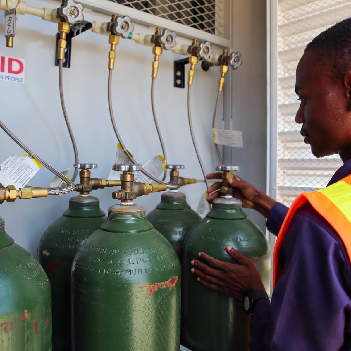 Felisberto Armando in front of the oxygen cylinders that he fills daily. 