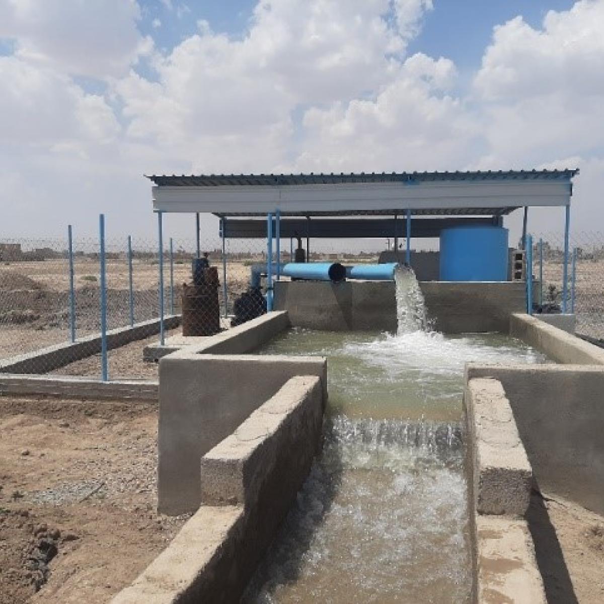 Water flows into a rehabilitated canal for farmers' use.