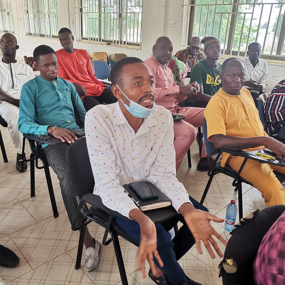 A man participates in a community dialogue session. 