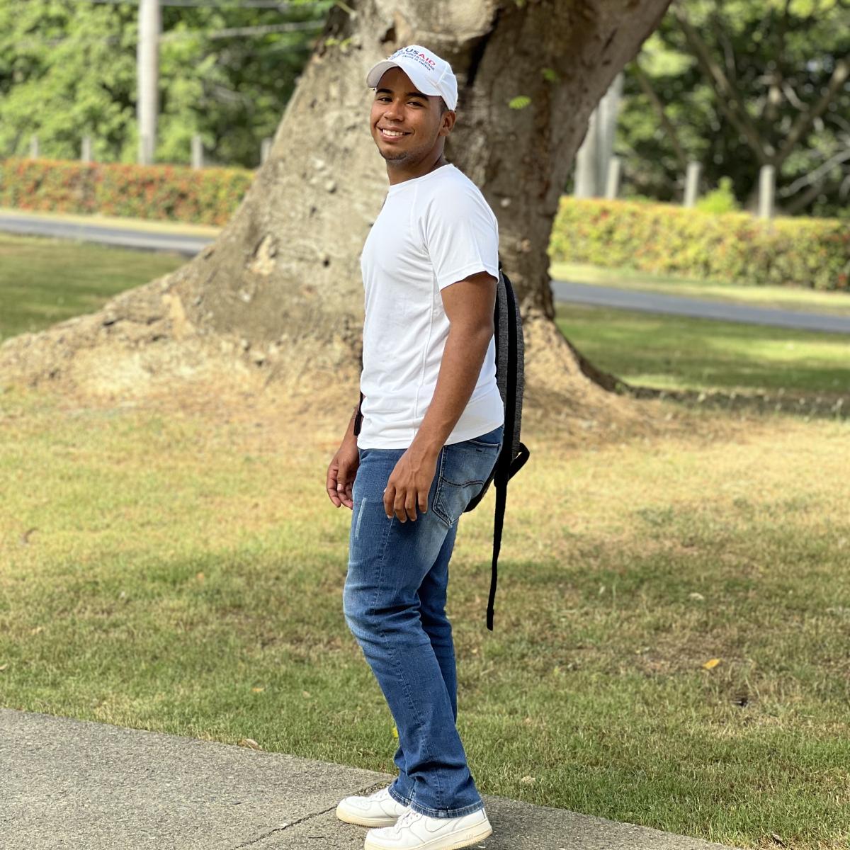 Jency, a young man from Dominican Republic, looks at the camera.