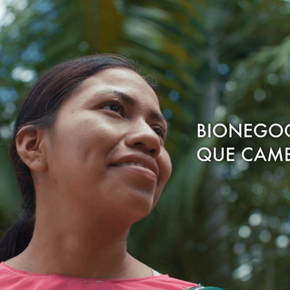 An indigenous woman staring optimistically in the Amazon rainforest