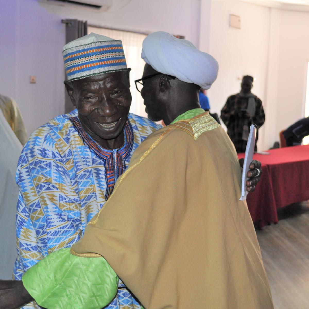 Two men embrace at the intra-Muslim PVE training. 