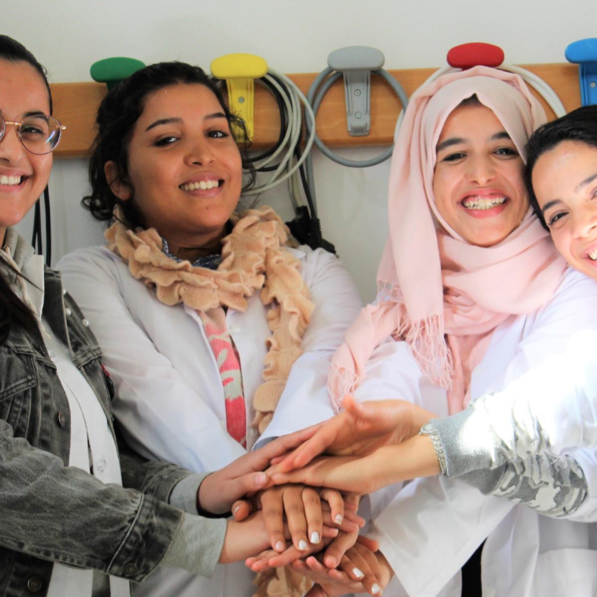 A group of women join hands