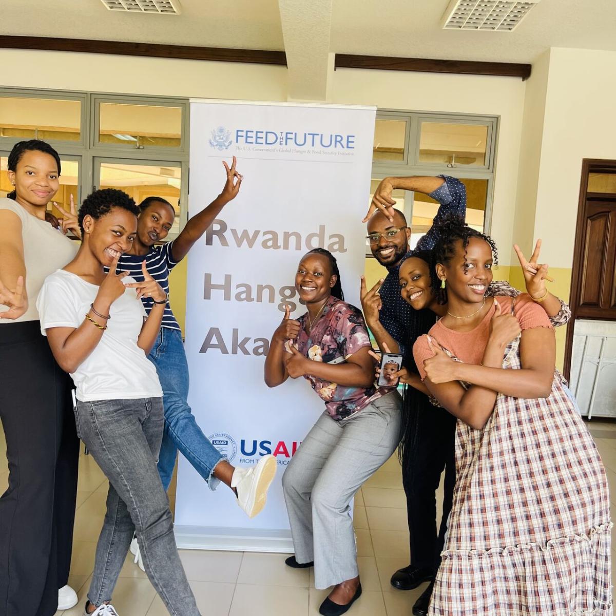 youth participants at the training standing in front of the project banner