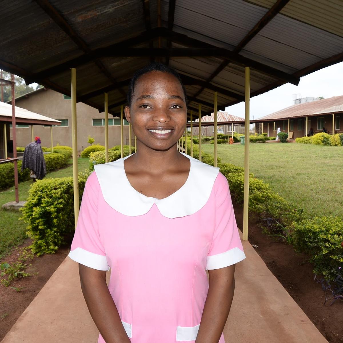 A young woman stands on a covered walkway