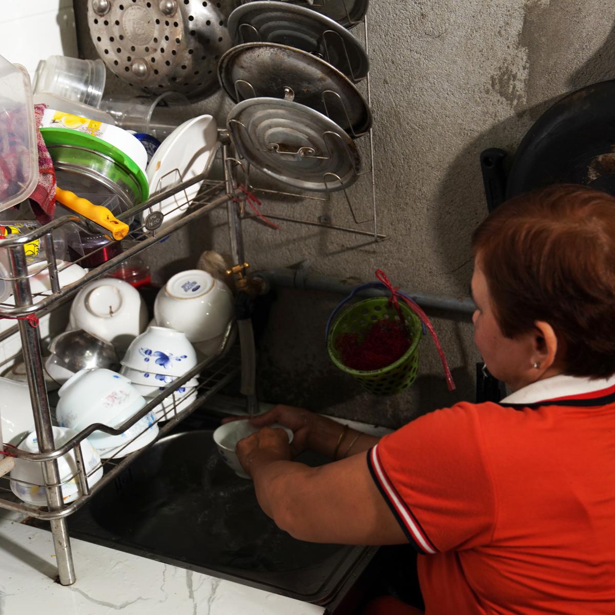 Mrs. Loa doing chores in her accesible house 