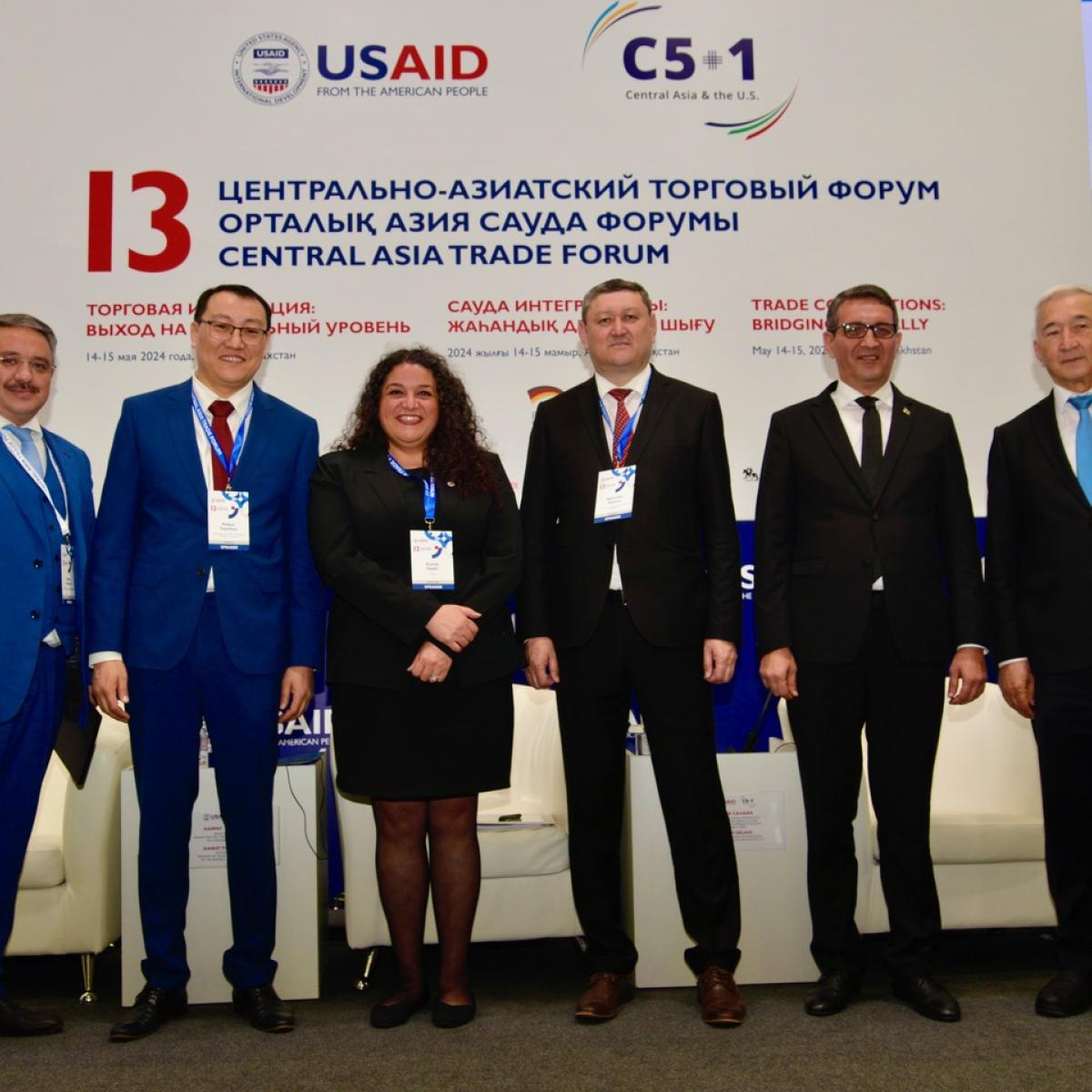 Speakers pose in front of speaker stage at CATF