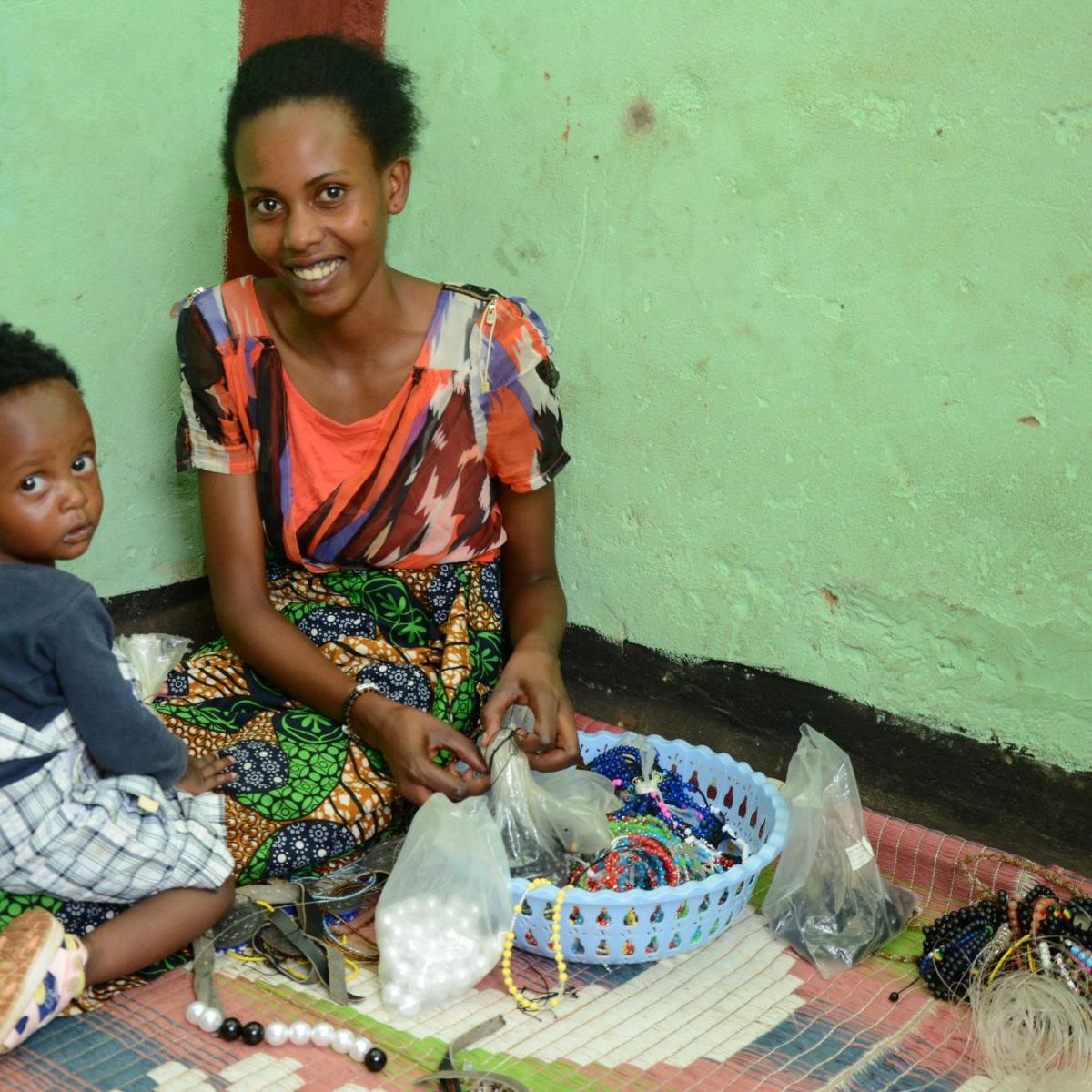 Denyse with her baby making jewelry. 