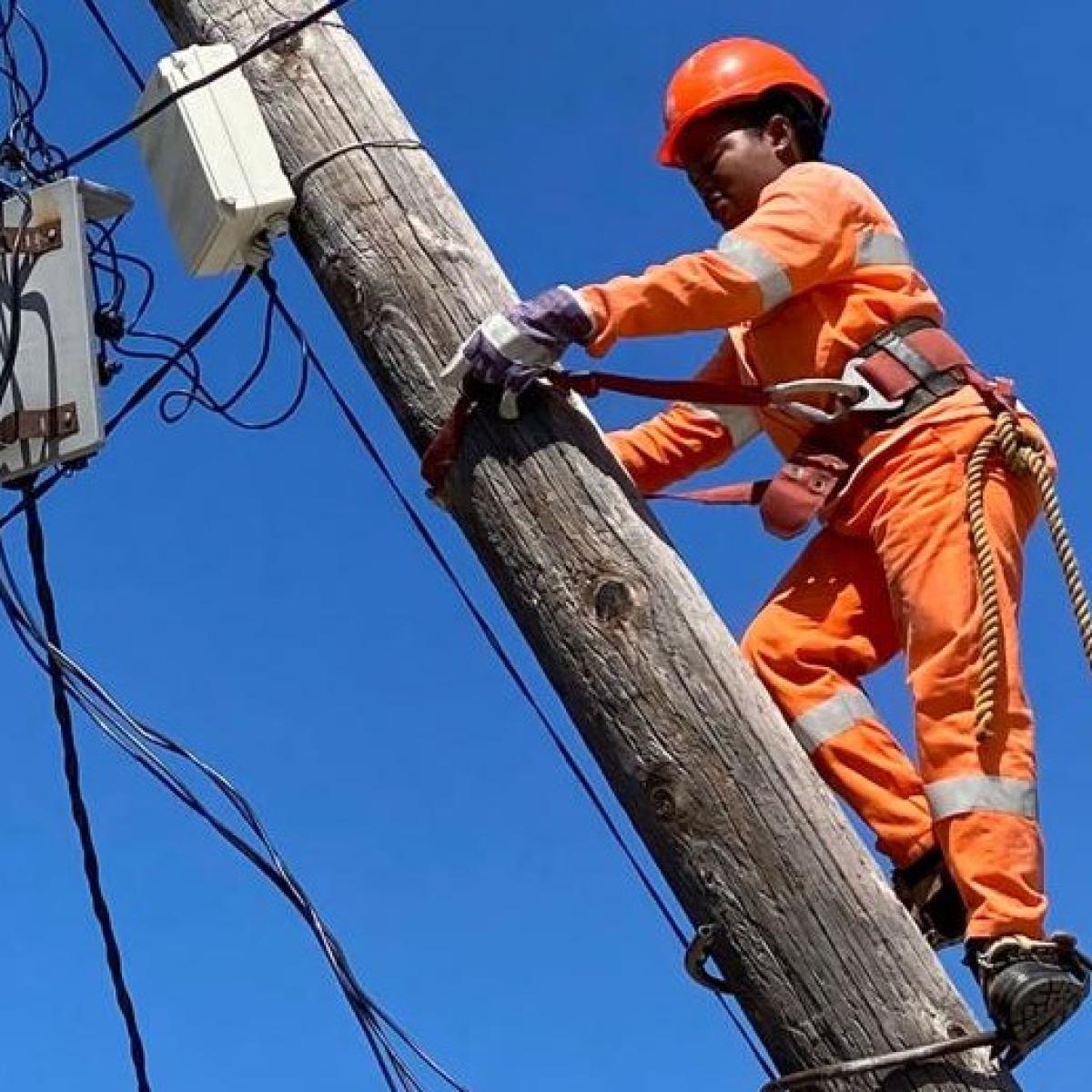 Woman climbing utility pole