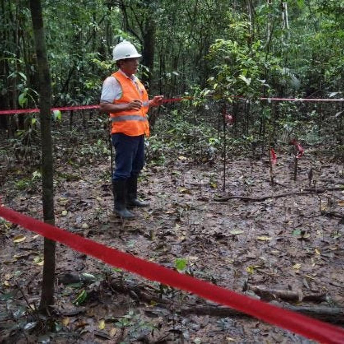 A man measuring and delimitating a parcel of land