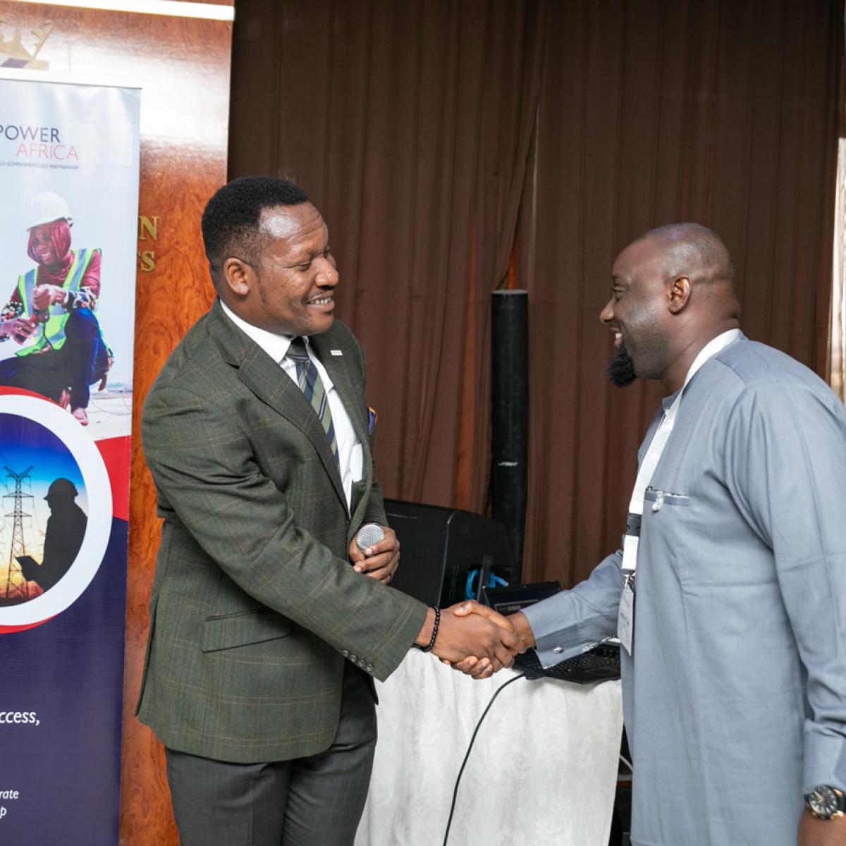 Two men shaking hands at an event