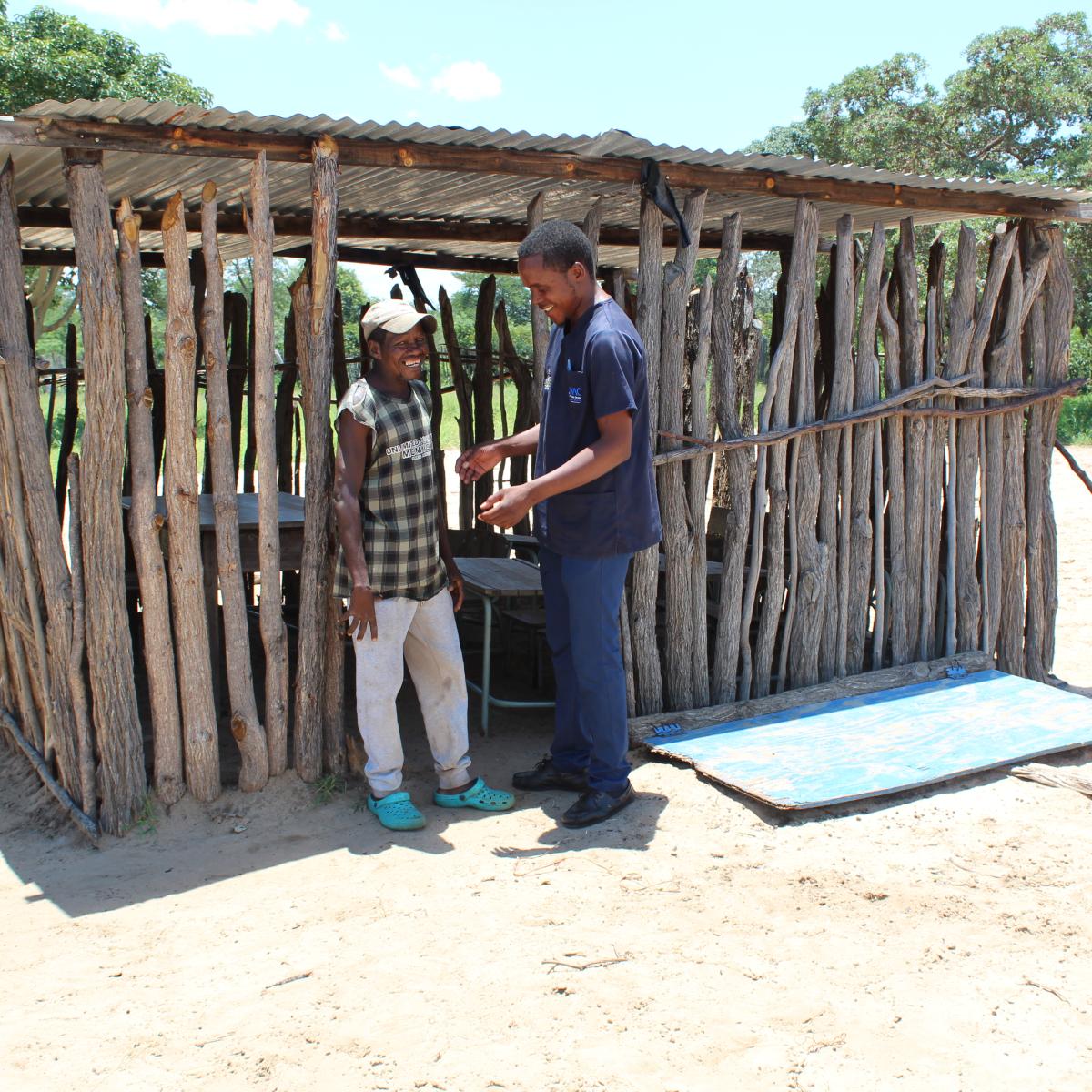  Ready for the smart-cut: A VMMC client discusses the advantages of circumcision with a nurse at the outreach room.