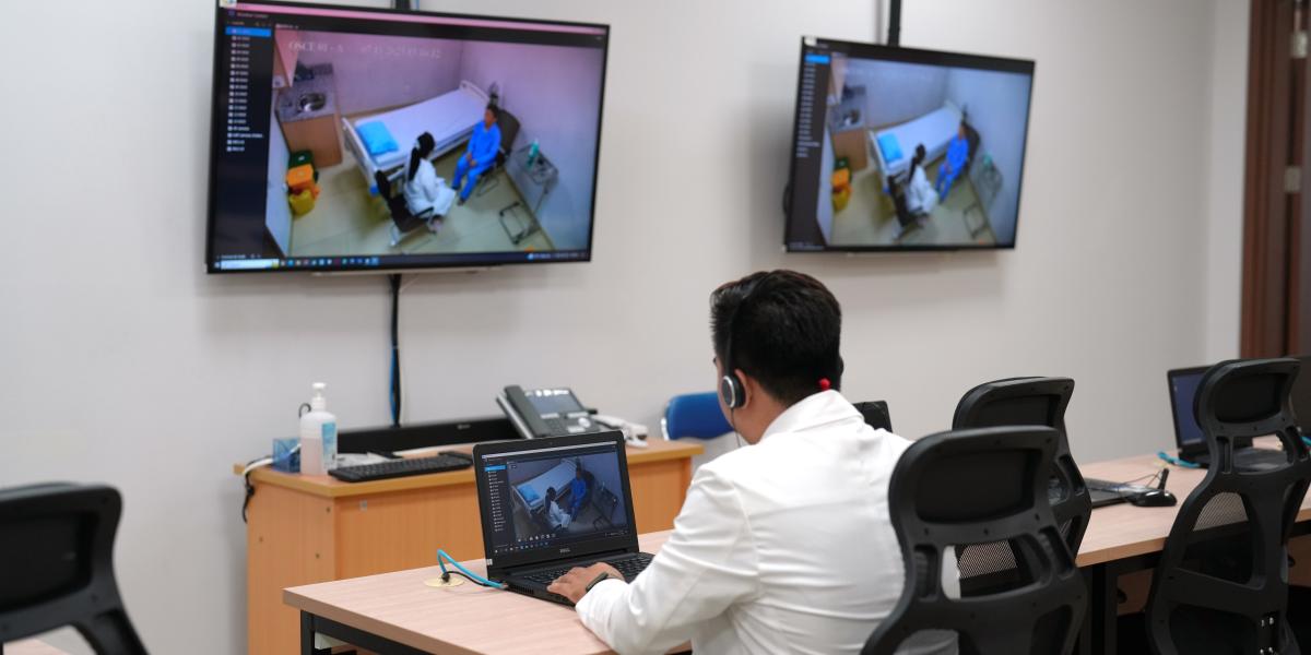 Faculty Watching Student in Consultation Room