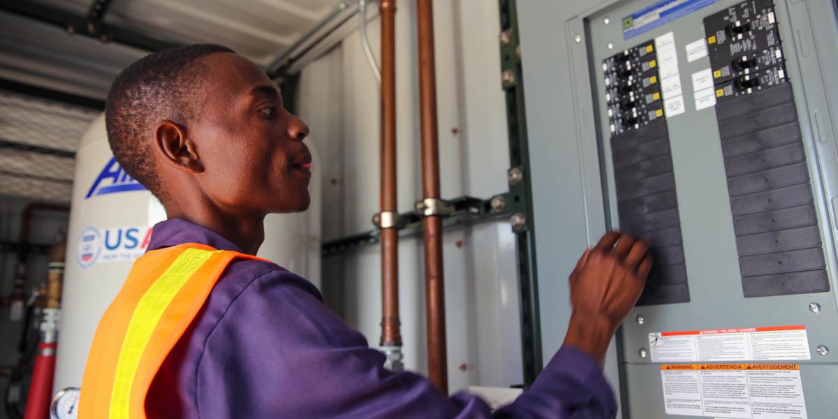 Felisberto operating the oxygen plant control system.