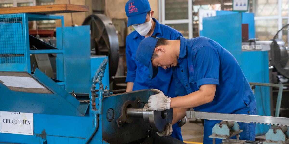 Two men working on a machine