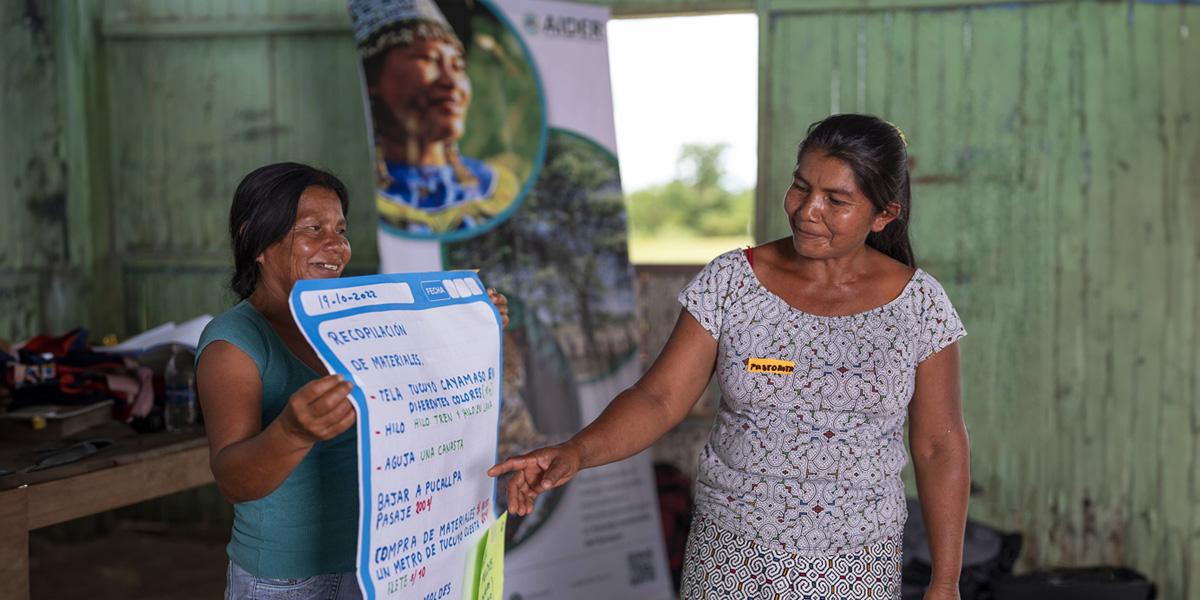 Two indigenous women doing a presentation