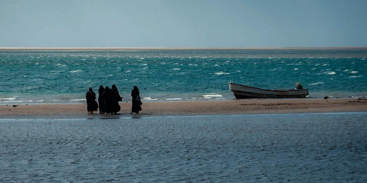 women walking on the beach