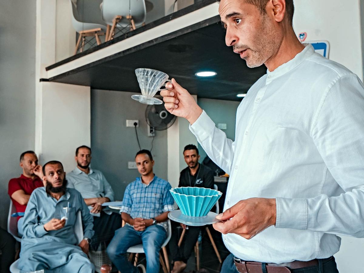 Trainer presents information about coffee to training participants 