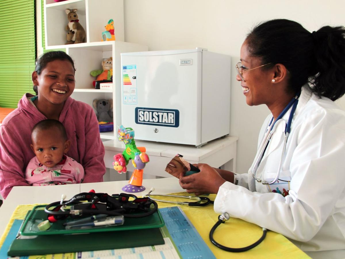 A health care worker consults with a mother in Madagascar