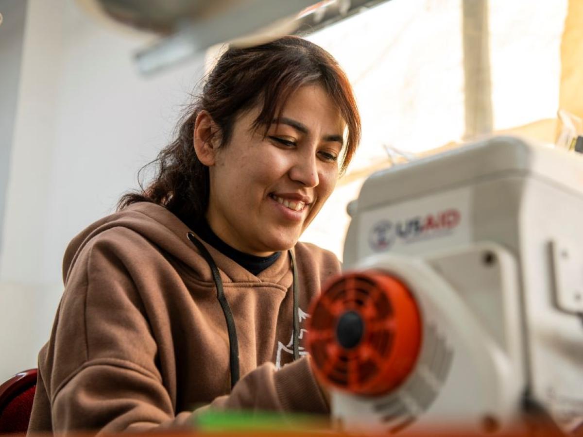 lady is working on a sewing machine