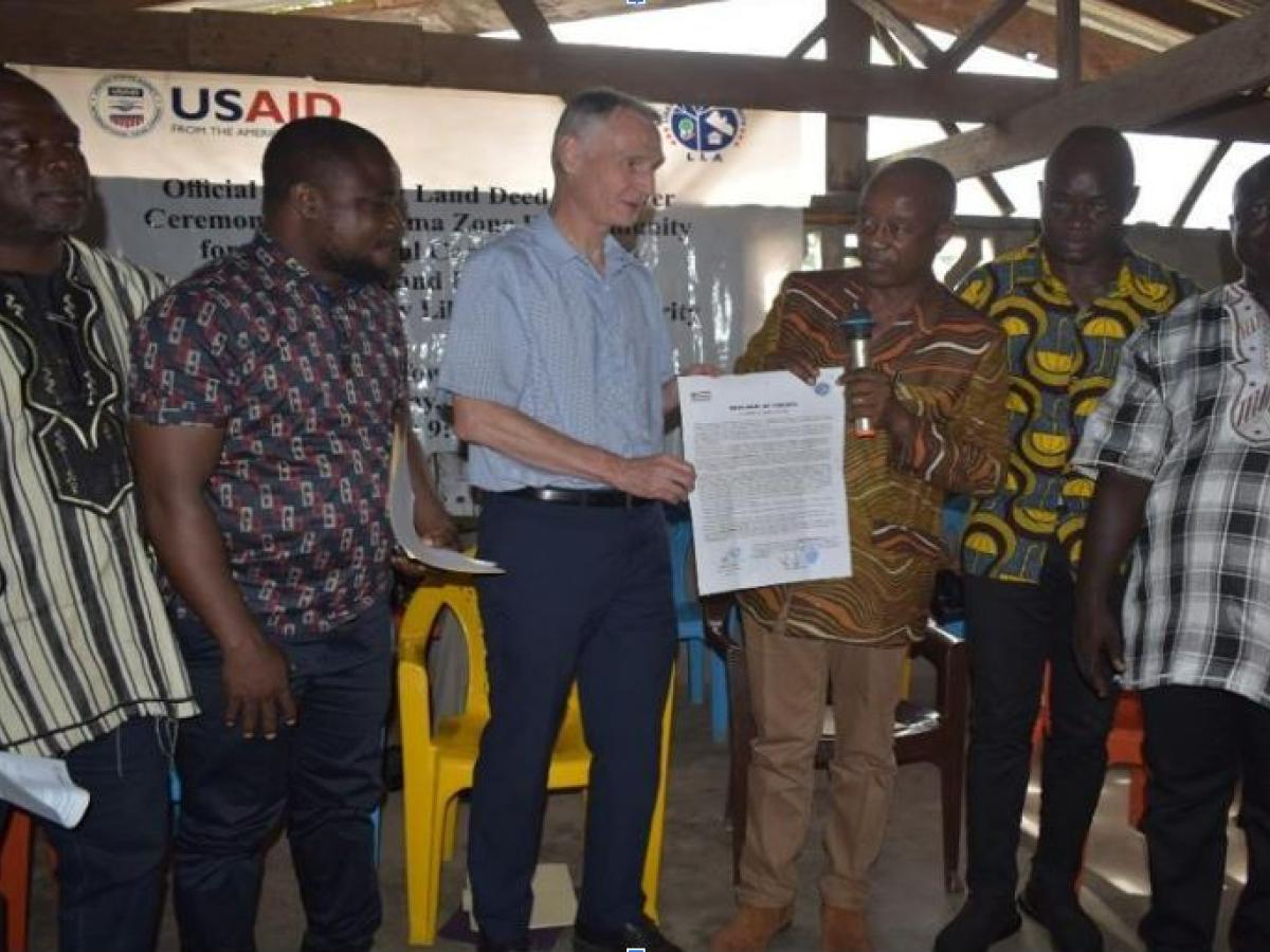 Jim Wright handing over first land deed to Bluyeama leadership