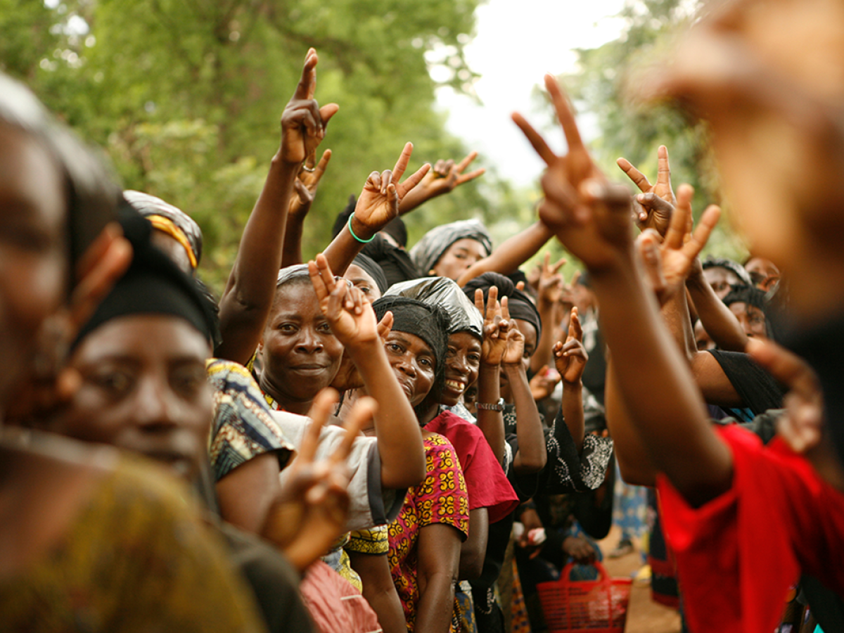 A group of women holding up peace signs