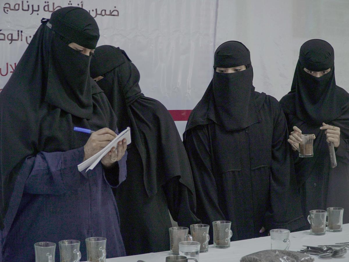 Women attend coffee training and take notes