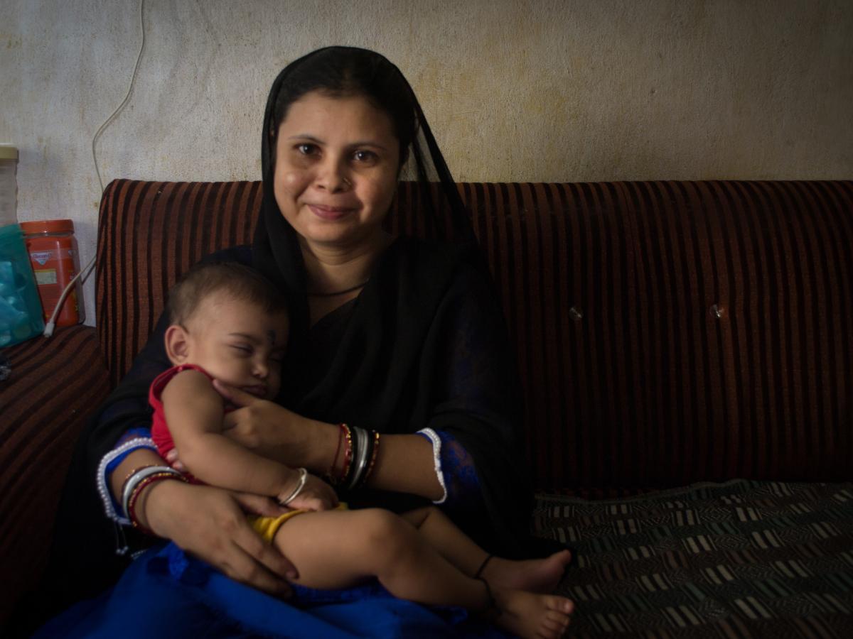 A mother in India smiles with her child